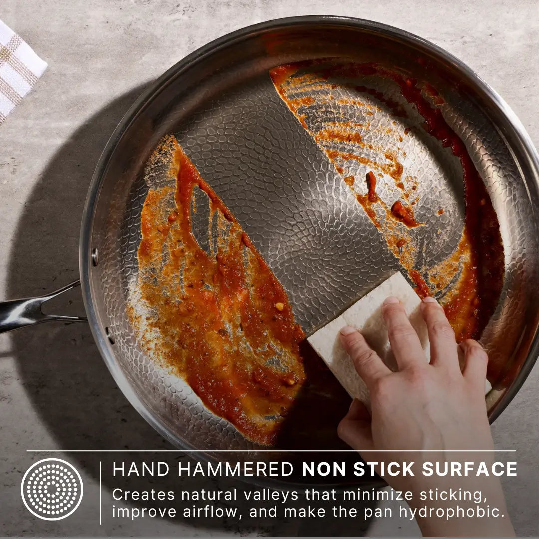 Wiping a Siraat Titanium Hammered Pan Pro Large clean, the hand hammered low-stick surface